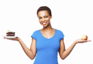 Choosing between cake or an apple - Isolated