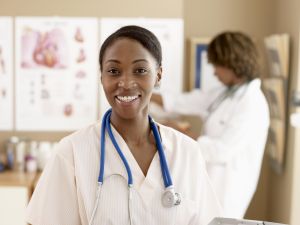 Female nurse standing with doctor, focus on nurse