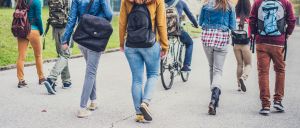 Group of unrecognizable sudents walking through the park