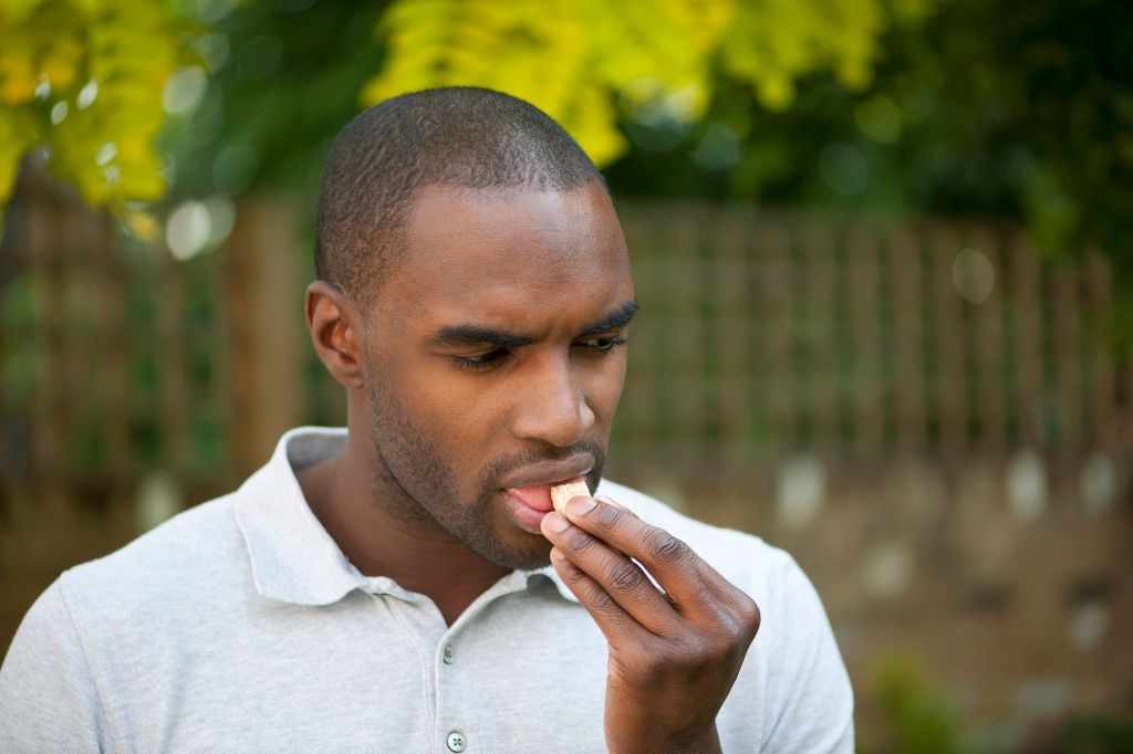Diabetic taking a glucose tablet