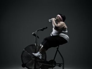 Overweight woman on exercise bike