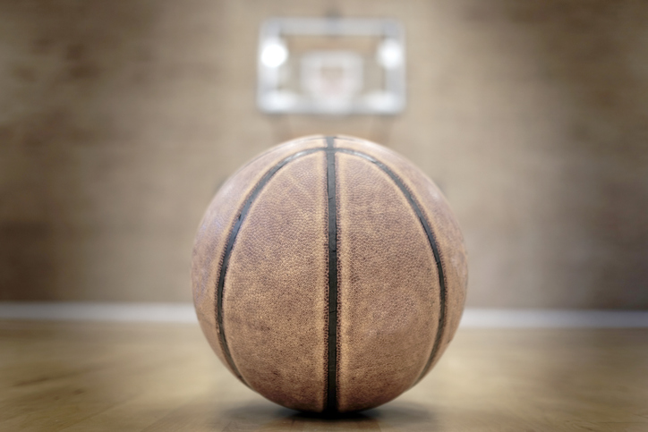 Basketball on Court with Hoops Rim Hardwood Floor Lights
